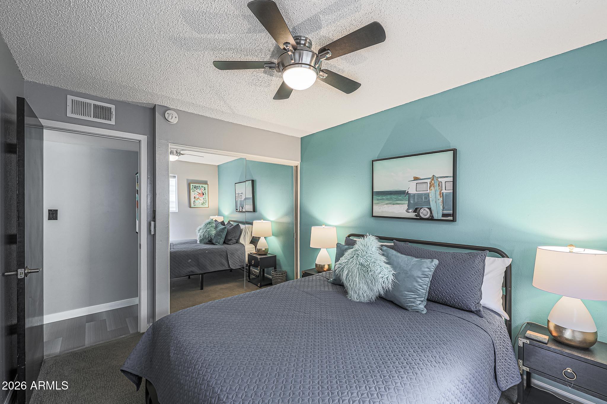 2201 East Marilyn Road Phoenix, AZ 85022 - Photo 35 of 47 a bedroom with bed and a chandelier