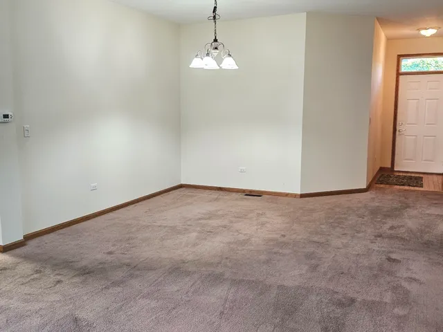 a view of a room with an empty space and a window