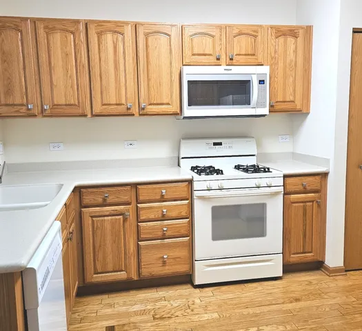 a kitchen with granite countertop white cabinets and stainless steel appliances