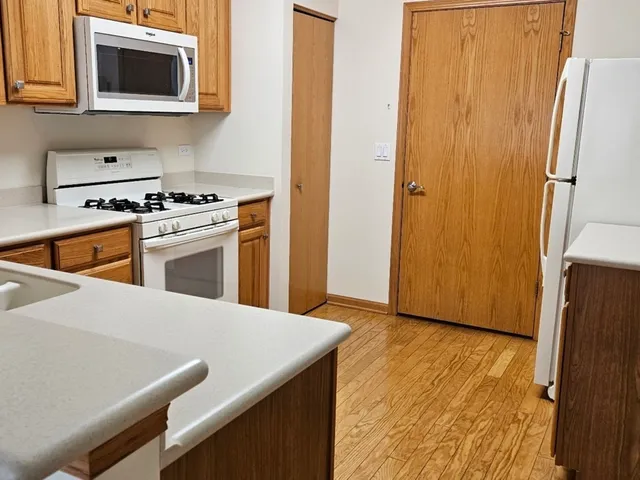 a kitchen with stainless steel appliances a stove a microwave and a refrigerator