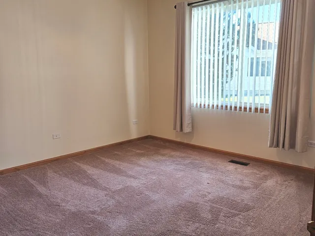 a view of an empty room and a window