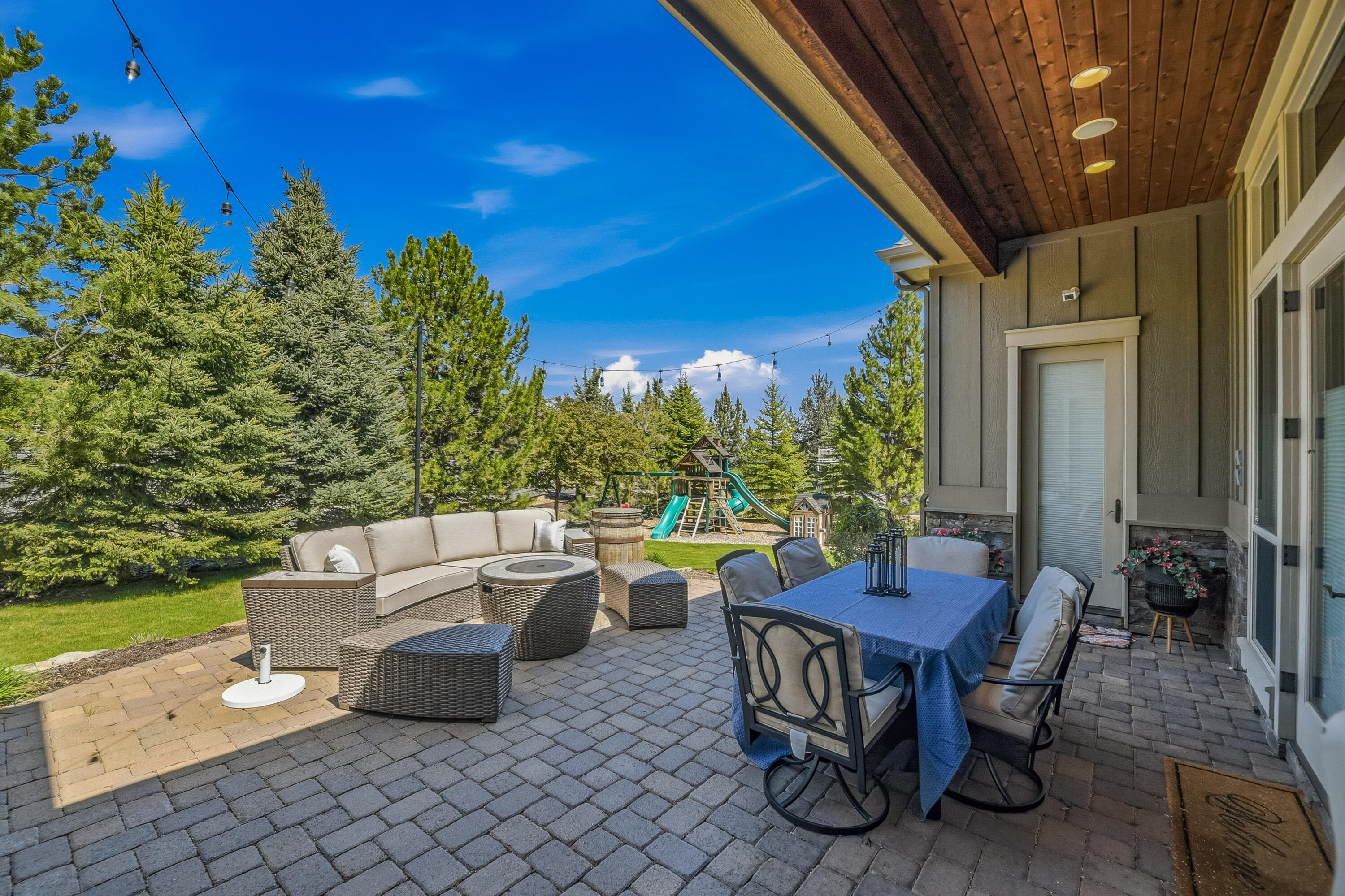 9009 Merlin Drive Redmond, OR 97756 - Photo 75 of 98 a view of a patio with a dining table and chairs with a small yard