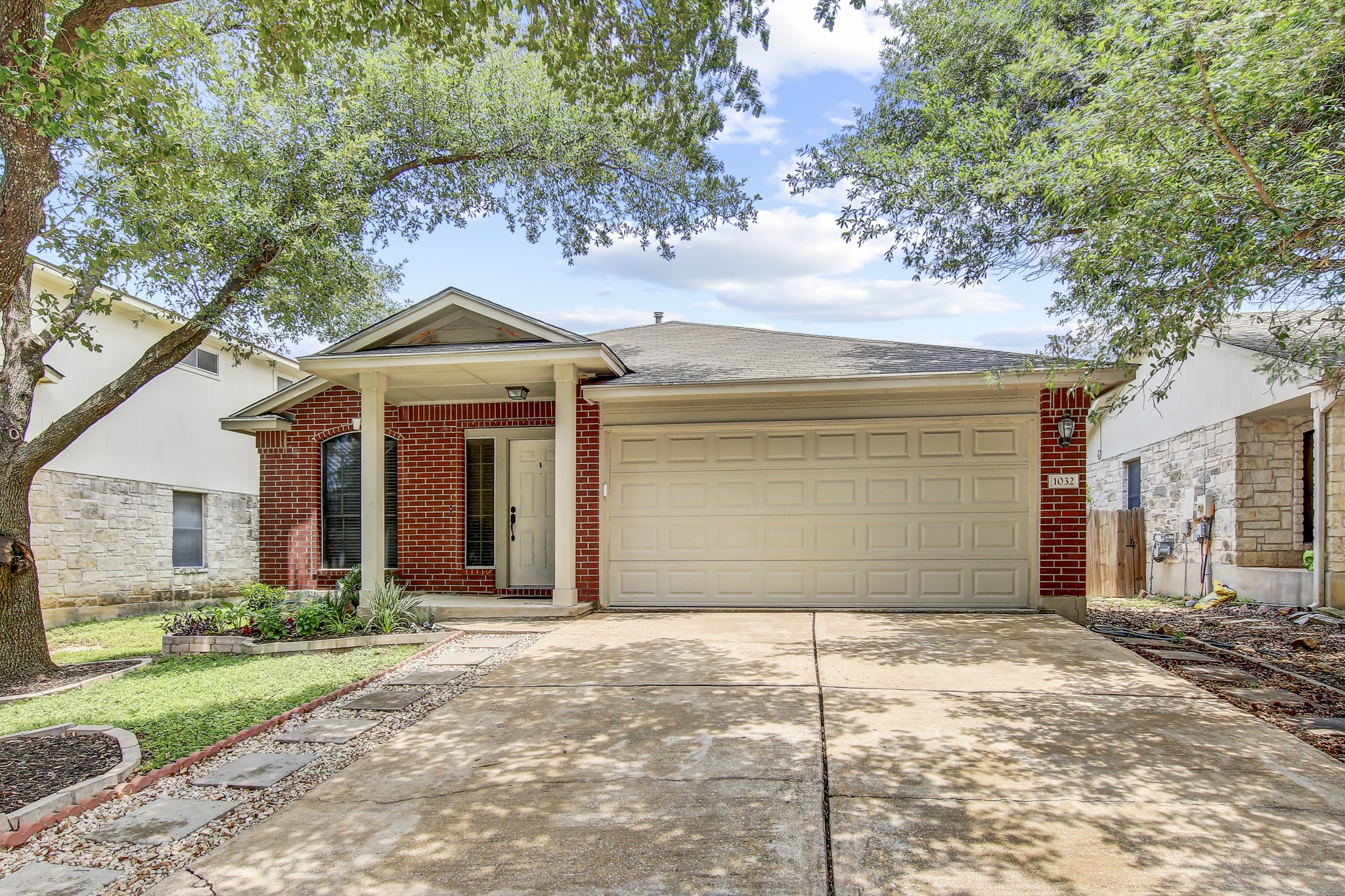 1032 Stacia's Way Pflugerville, TX 78660 - Photo 1 of 1 Single story home with driveway, a garage, brick siding, and roof with shingles