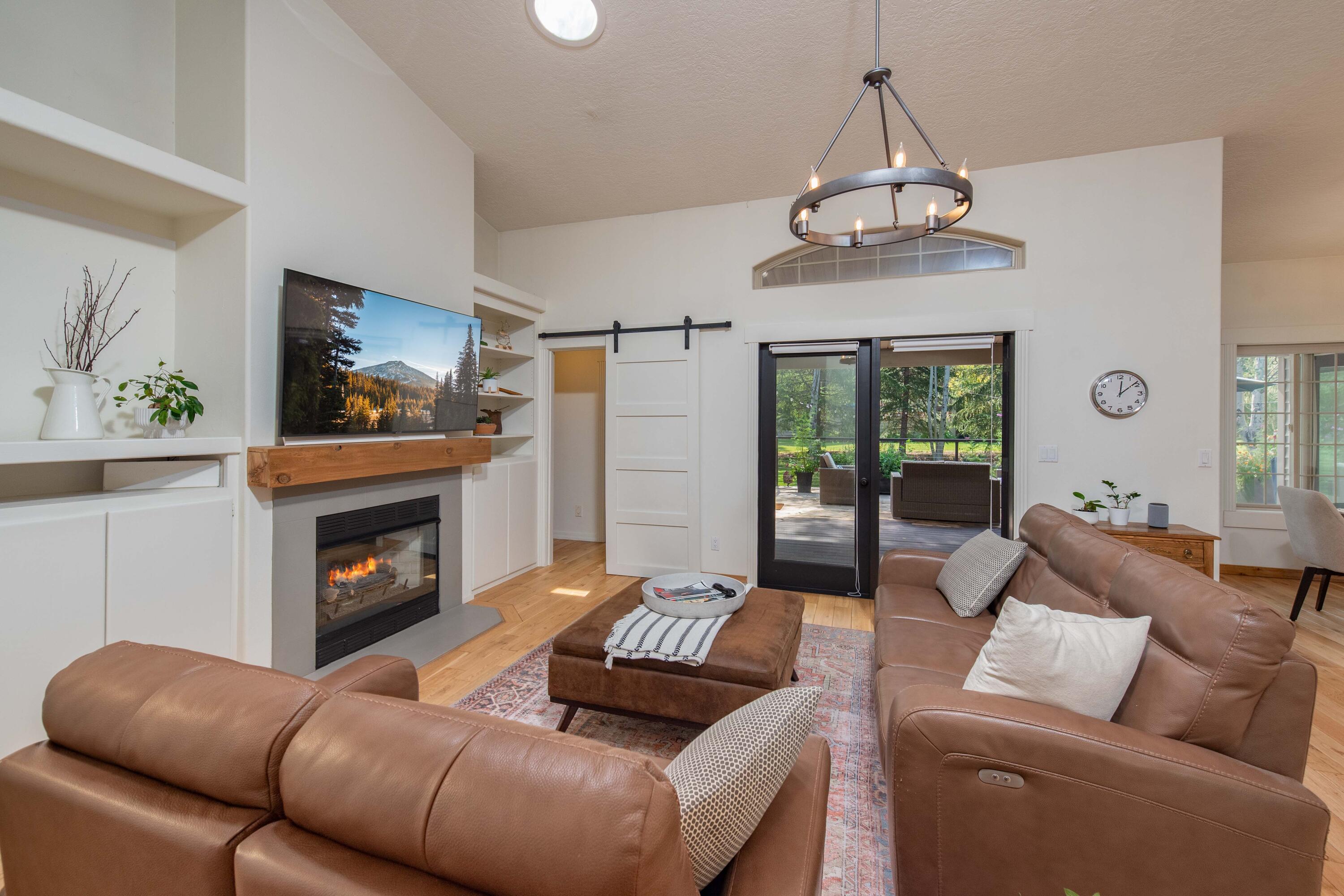 2701 Northwest Strath Way Bend, OR 97703 - Photo 14 of 41 The gas fireplace with built in cabinetry on either side is a focal point for enjoying cozy fall evenings.