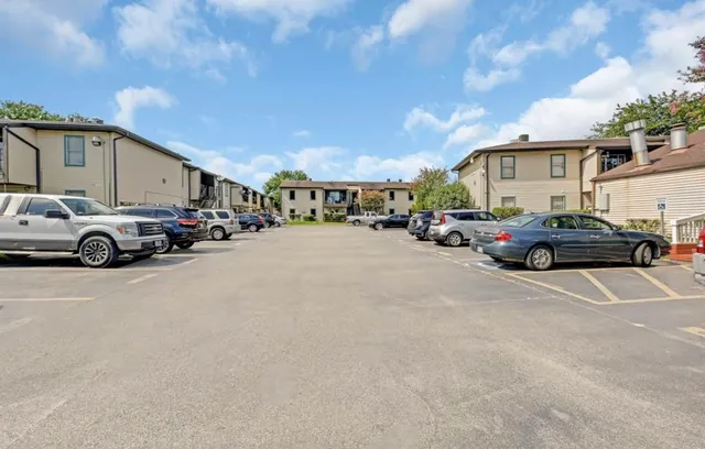 a view of a cars park in front of a building