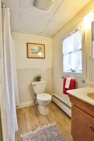 a bathroom with a toilet sink and window