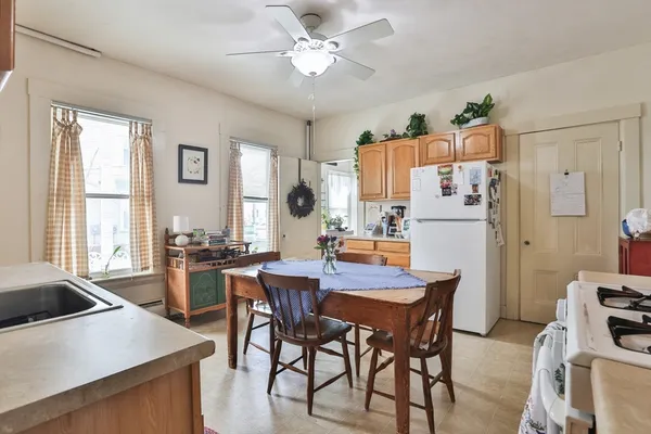 a view of a dining room with furniture and a window