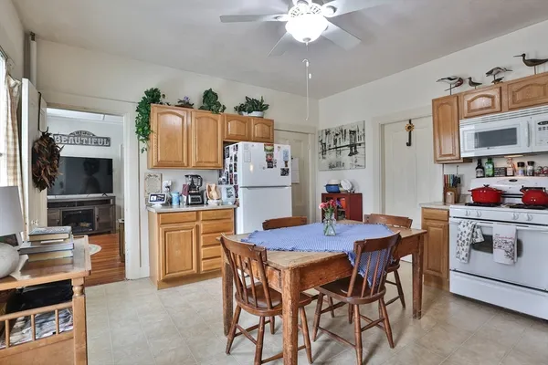 a dining table with chairs and kitchen view of kitchen