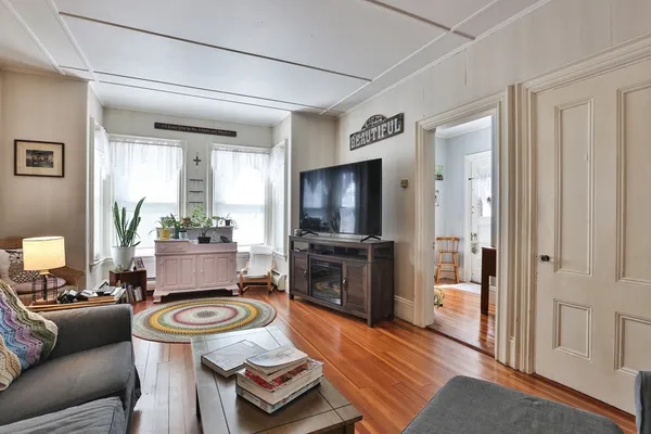 a living room with furniture and a flat screen tv
