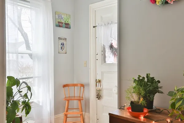 a dining room with furniture and a potted plant
