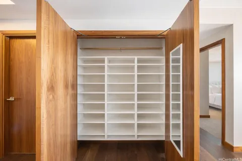 a view of walk in closet with empty racks