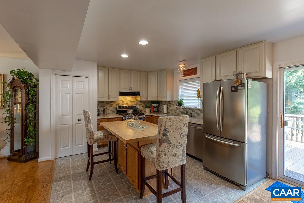 1229 Clover Ridge Place Charlottesville, VA 22901 - Photo 9 of 28 a kitchen with stainless steel appliances granite countertop a refrigerator a sink a stove and a refrigerator with wooden floor