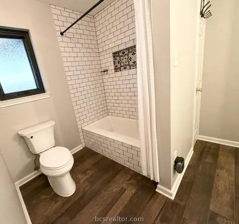 a view of a backyard with wooden fence