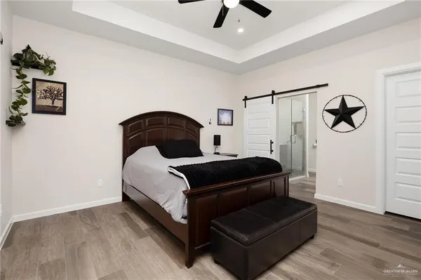 a bedroom with a bed and a ceiling fan
