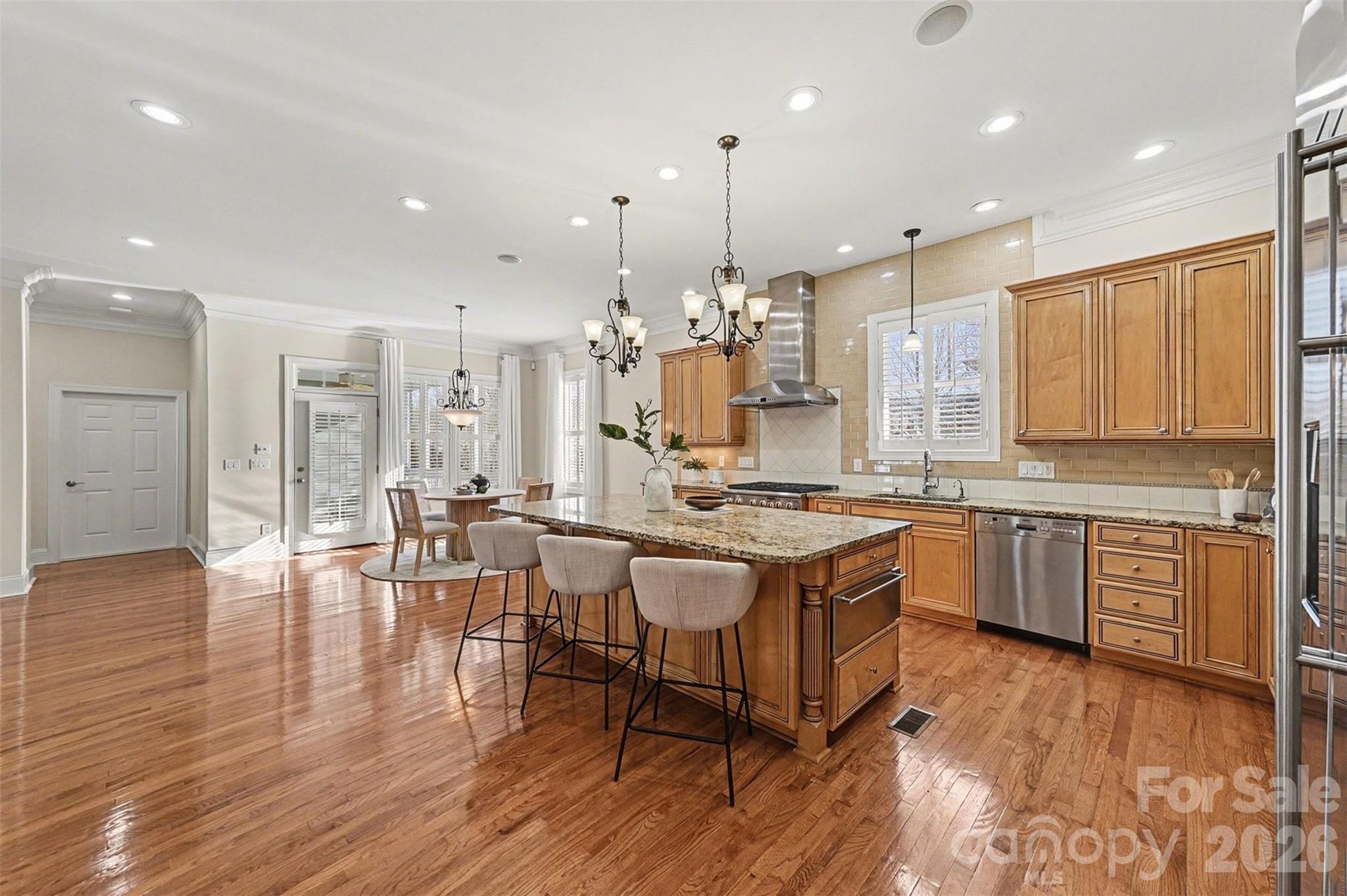 17531 Meadow Bottom Road Charlotte, NC 28277 - Photo 14 of 47 a large kitchen with lots of counter space dining table and stainless steel appliances