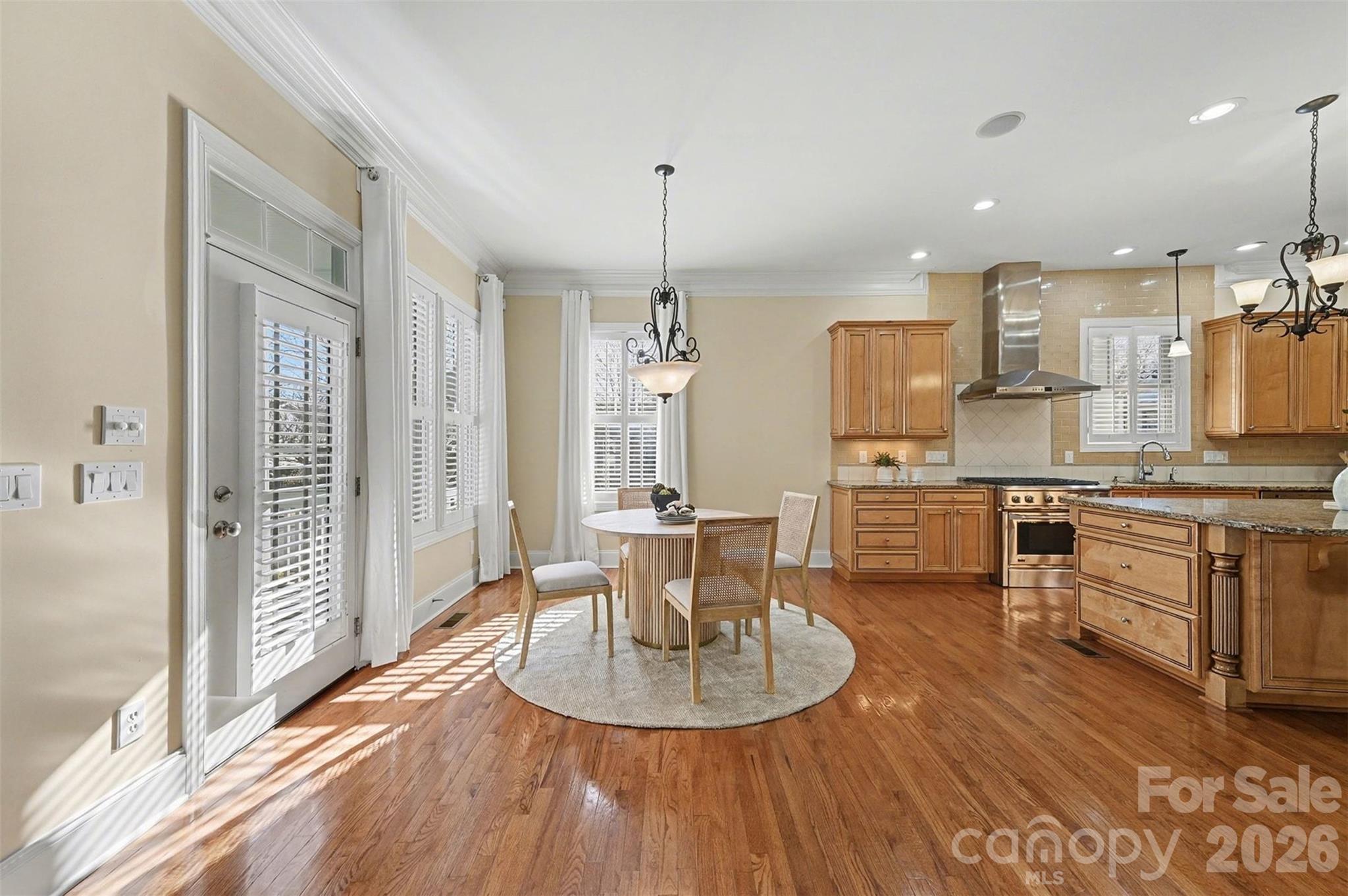 17531 Meadow Bottom Road Charlotte, NC 28277 - Photo 16 of 47 a kitchen with kitchen island granite countertop a stove a sink a refrigerator and white cabinets with wooden floor