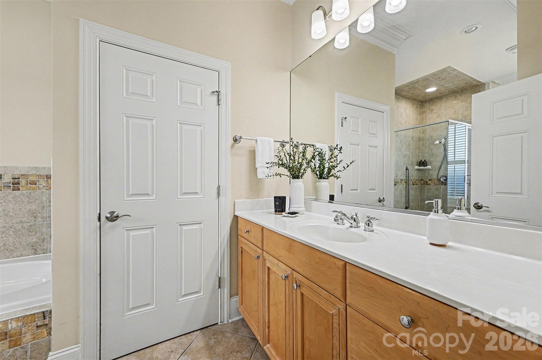 17531 Meadow Bottom Road Charlotte, NC 28277 - Photo 27 of 47 a bathroom with a double vanity sink a mirror and a shower