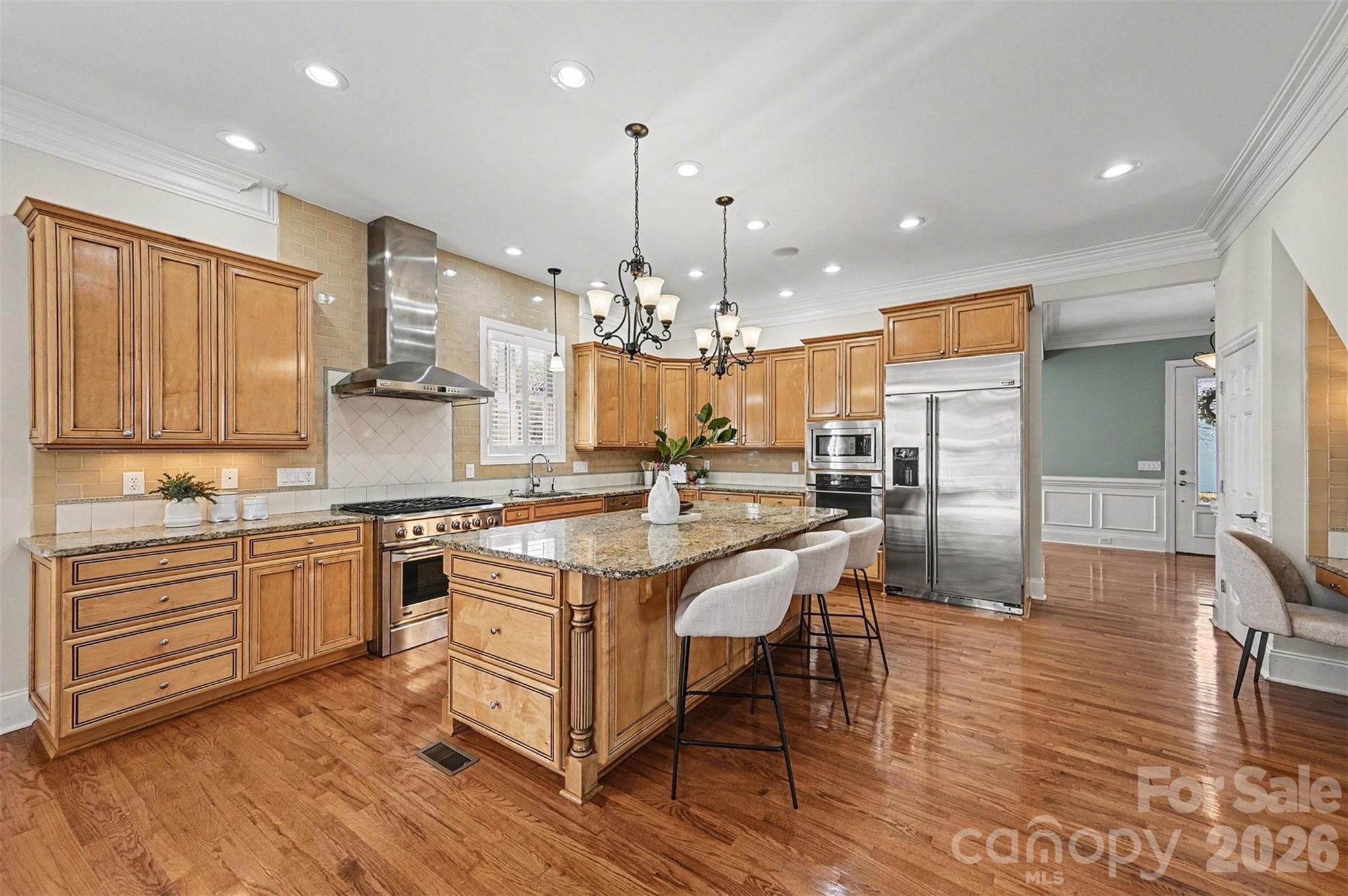 17531 Meadow Bottom Road Charlotte, NC 28277 - Photo 9 of 47 a kitchen with stainless steel appliances granite countertop a stove top oven a sink dishwasher and a dining table with wooden floor