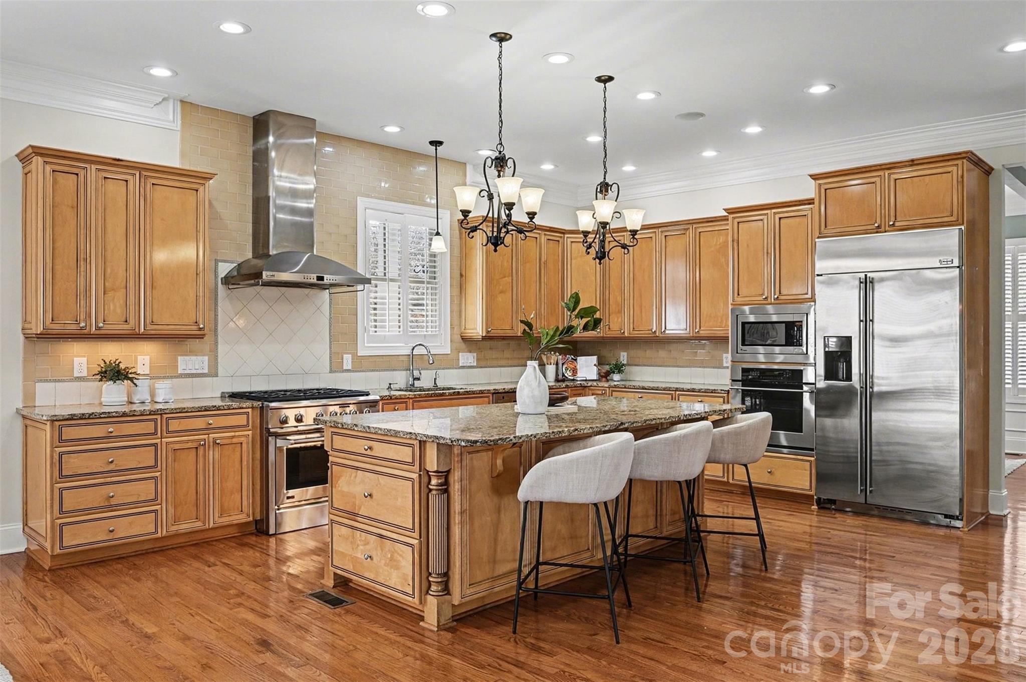 17531 Meadow Bottom Road Charlotte, NC 28277 - Photo 10 of 47 a kitchen with kitchen island granite countertop wooden cabinets and refrigerator