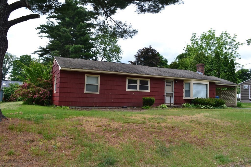 67 Bigelow Road Lancaster, MA 01523 - Photo 1 of 8 a view of a yard in front of a house with large trees