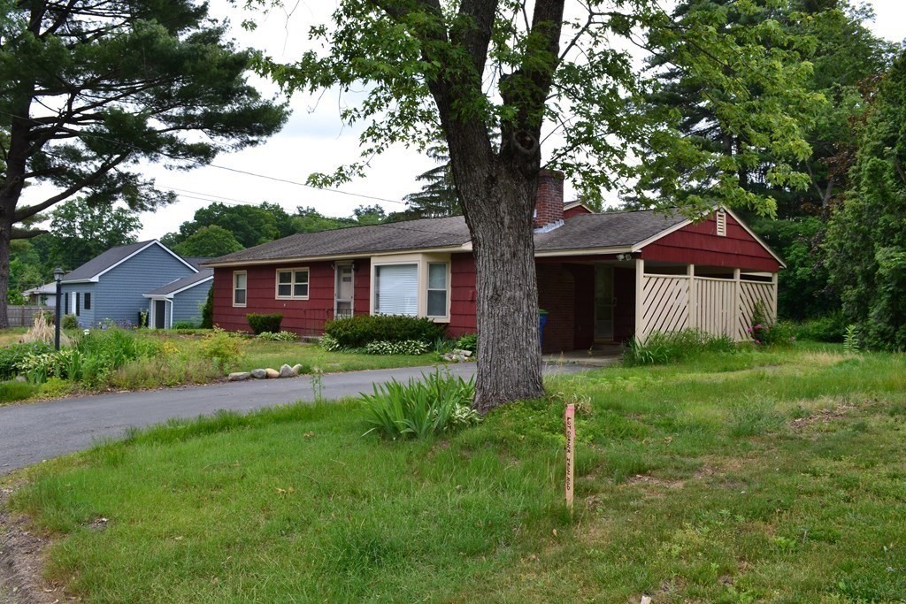 67 Bigelow Road Lancaster, MA 01523 - Photo 2 of 8 a front view of a house with a yard and garage