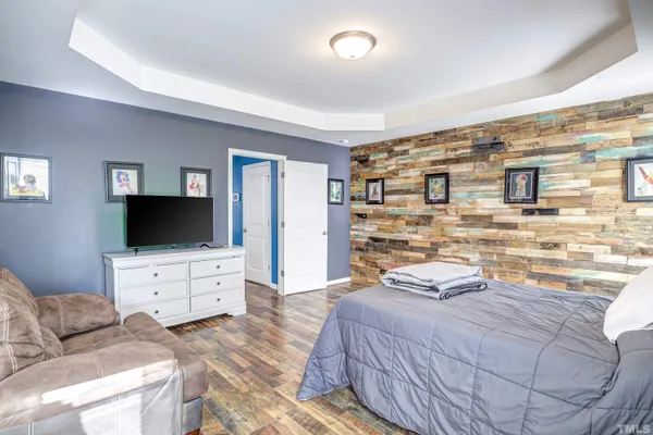 a bedroom with a bed and a flat screen tv