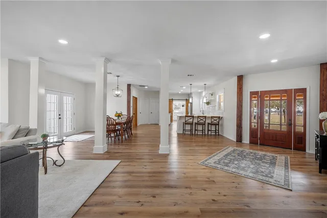 a living room with furniture and wooden floor