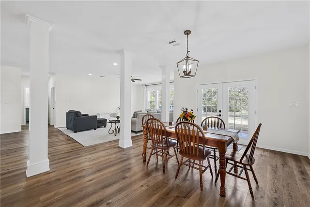 a view of a dining room with furniture window and wooden floor