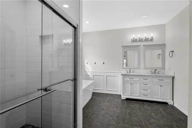 a bathroom with a double vanity sink a mirror and a shower