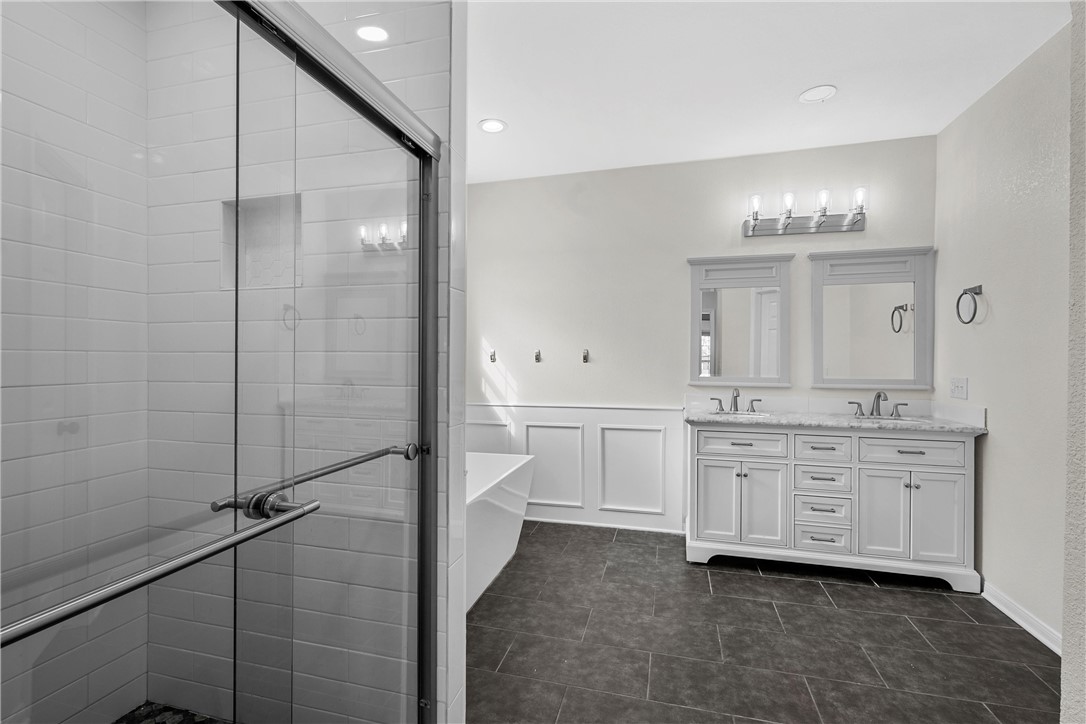 15966 Old China Spring Road China Spring, TX 76633 - Photo 26 of 45 a bathroom with a double vanity sink a mirror and a shower