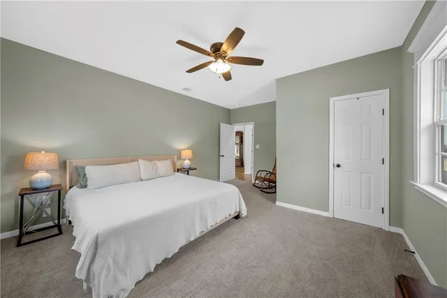 a bedroom with a bed and window