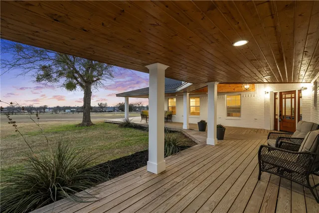 a view of a patio with wooden floor