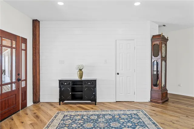 a view of a bedroom with furniture and window