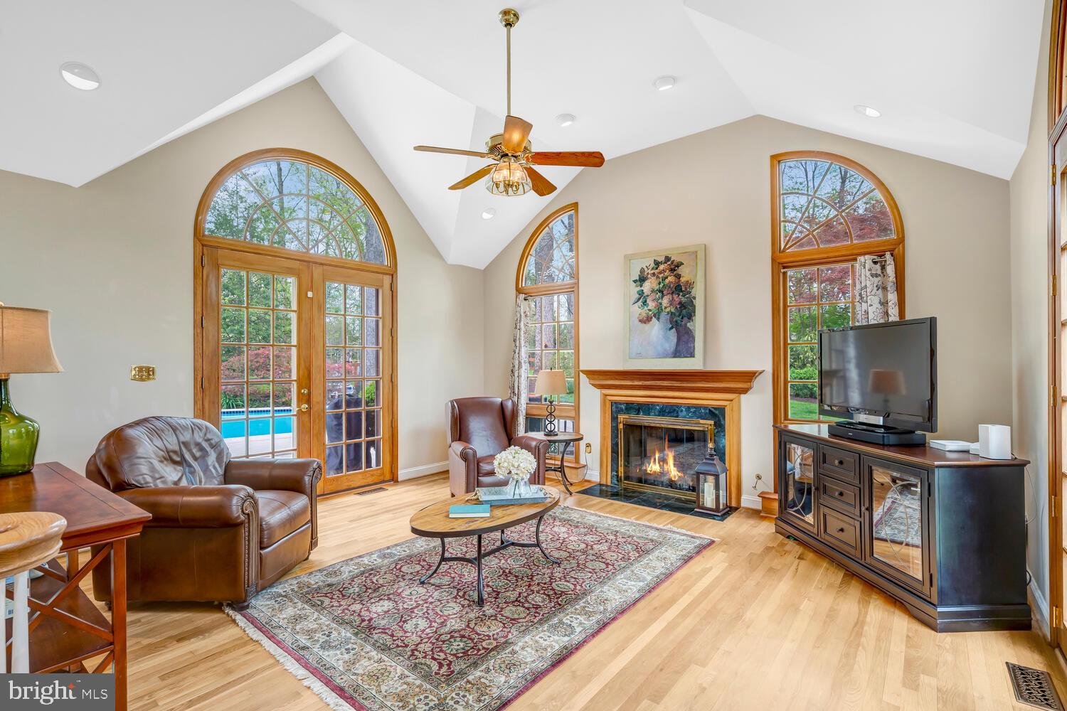 723 Forest Park Road Great Falls, VA 22066 - Photo 31 of 71 a living room with furniture a fireplace and a flat screen tv
