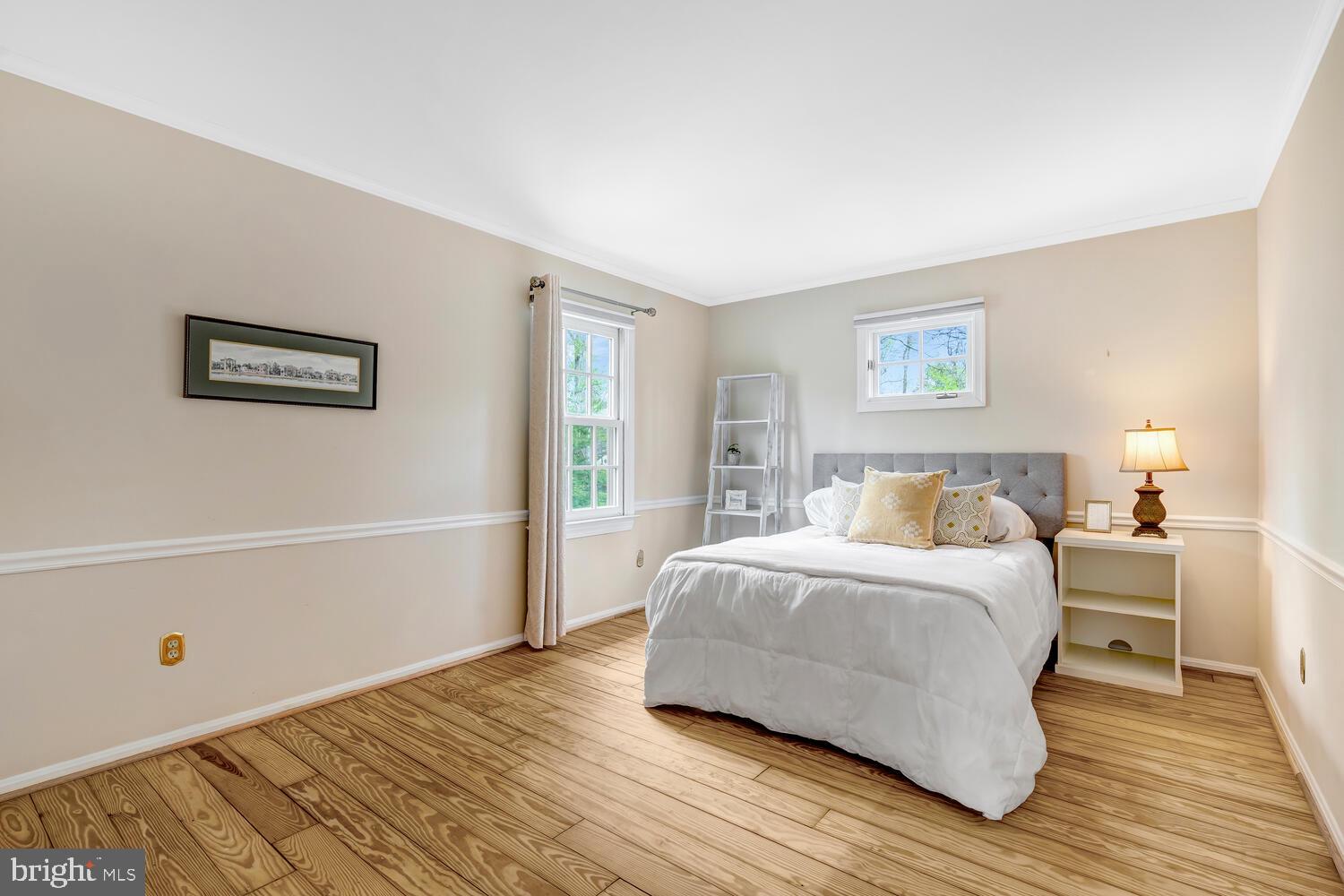 723 Forest Park Road Great Falls, VA 22066 - Photo 33 of 71 a bedroom with a bed and wooden floor