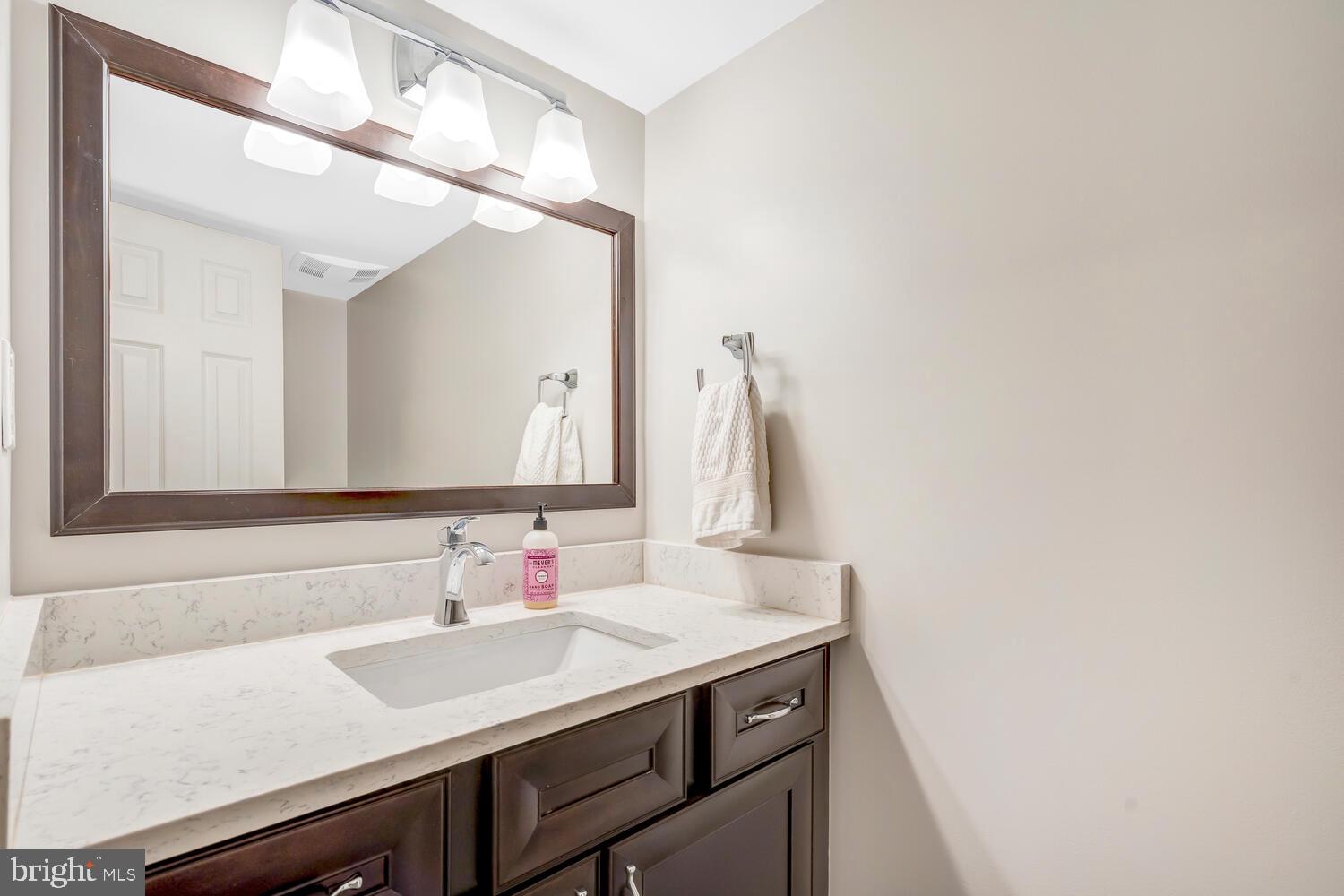 723 Forest Park Road Great Falls, VA 22066 - Photo 44 of 71 a bathroom with a sink and a mirror