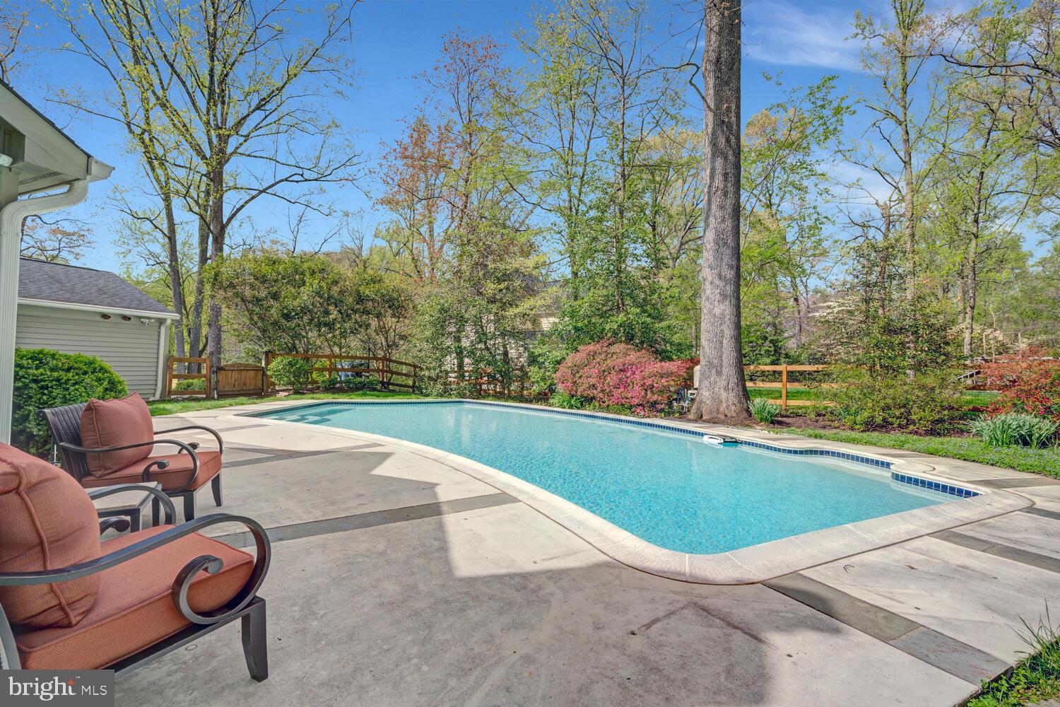 723 Forest Park Road Great Falls, VA 22066 - Photo 57 of 71 a view of swimming pool with seating area and trees around