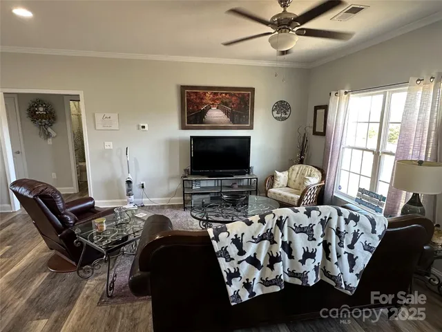 a bedroom with furniture and a flat screen tv