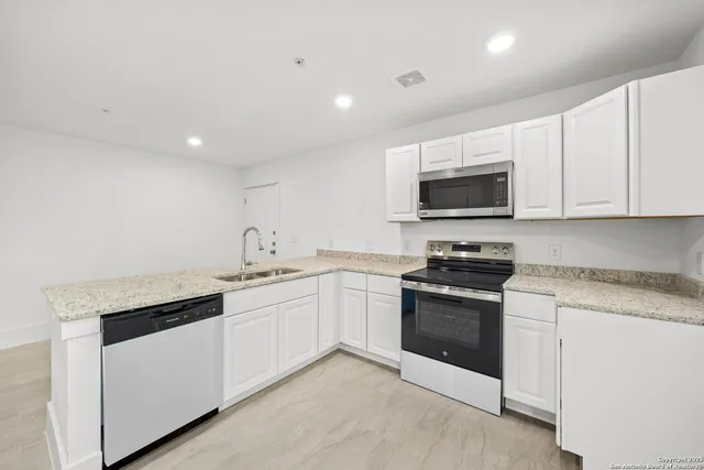 a kitchen with stainless steel appliances granite countertop a stove and a sink
