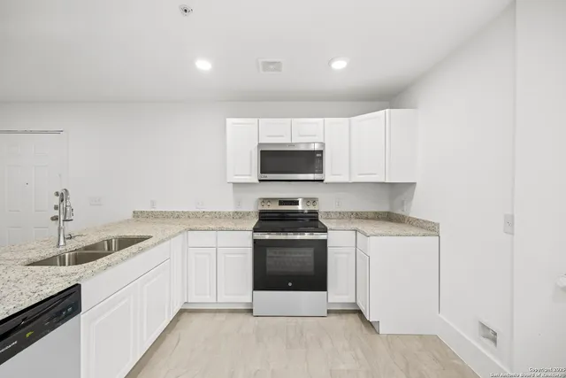 a kitchen with a sink cabinets and utility