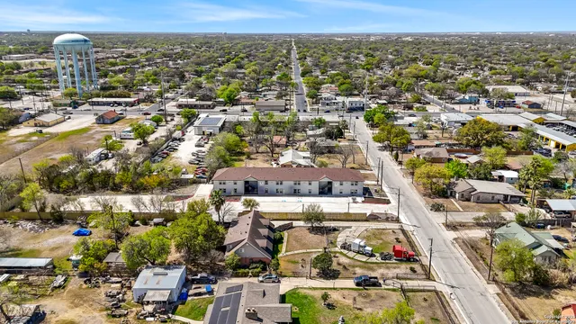 an aerial view of residential houses with city view