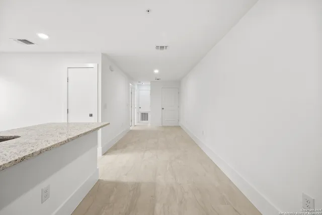 a view of kitchen with stainless steel appliances refrigerator sink and cabinets