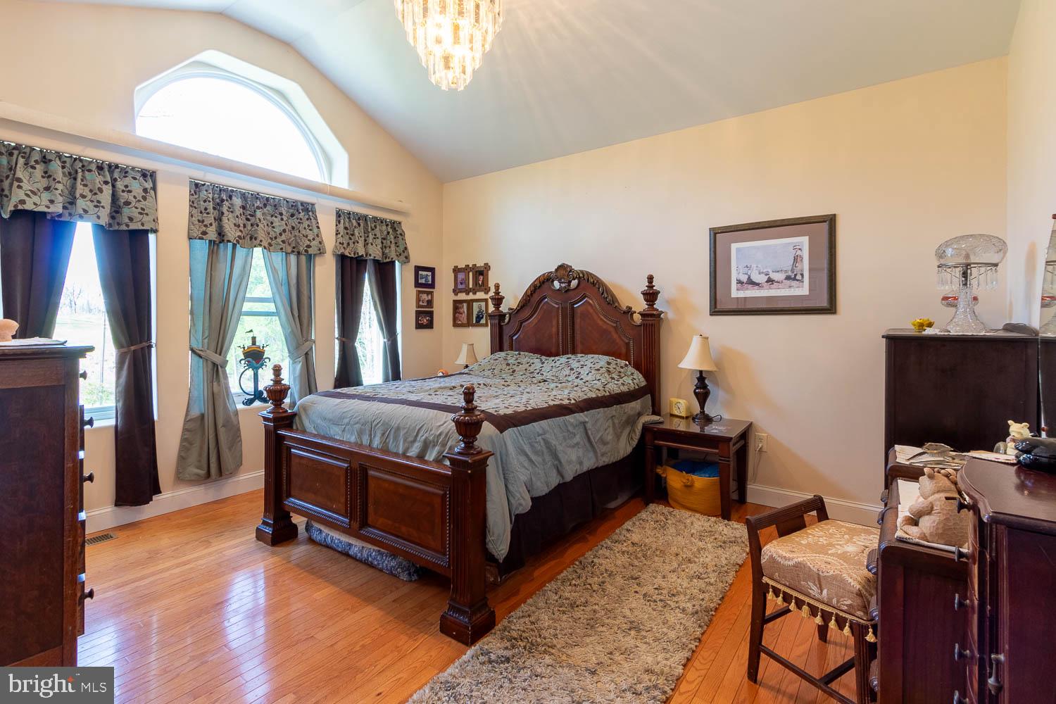 321 Mount Nittany Road Lemont, PA 16851 - Photo 12 of 43 a bedroom with a bed and wooden floor
