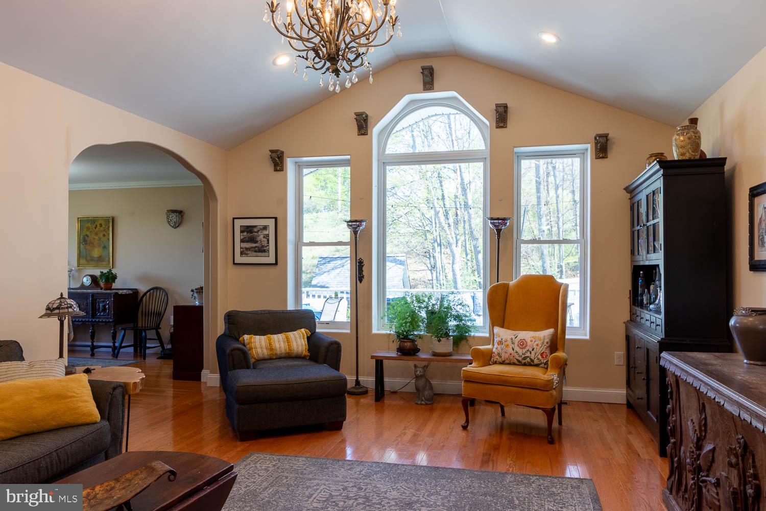 321 Mount Nittany Road Lemont, PA 16851 - Photo 2 of 43 a living room with furniture a fireplace and a flat screen tv