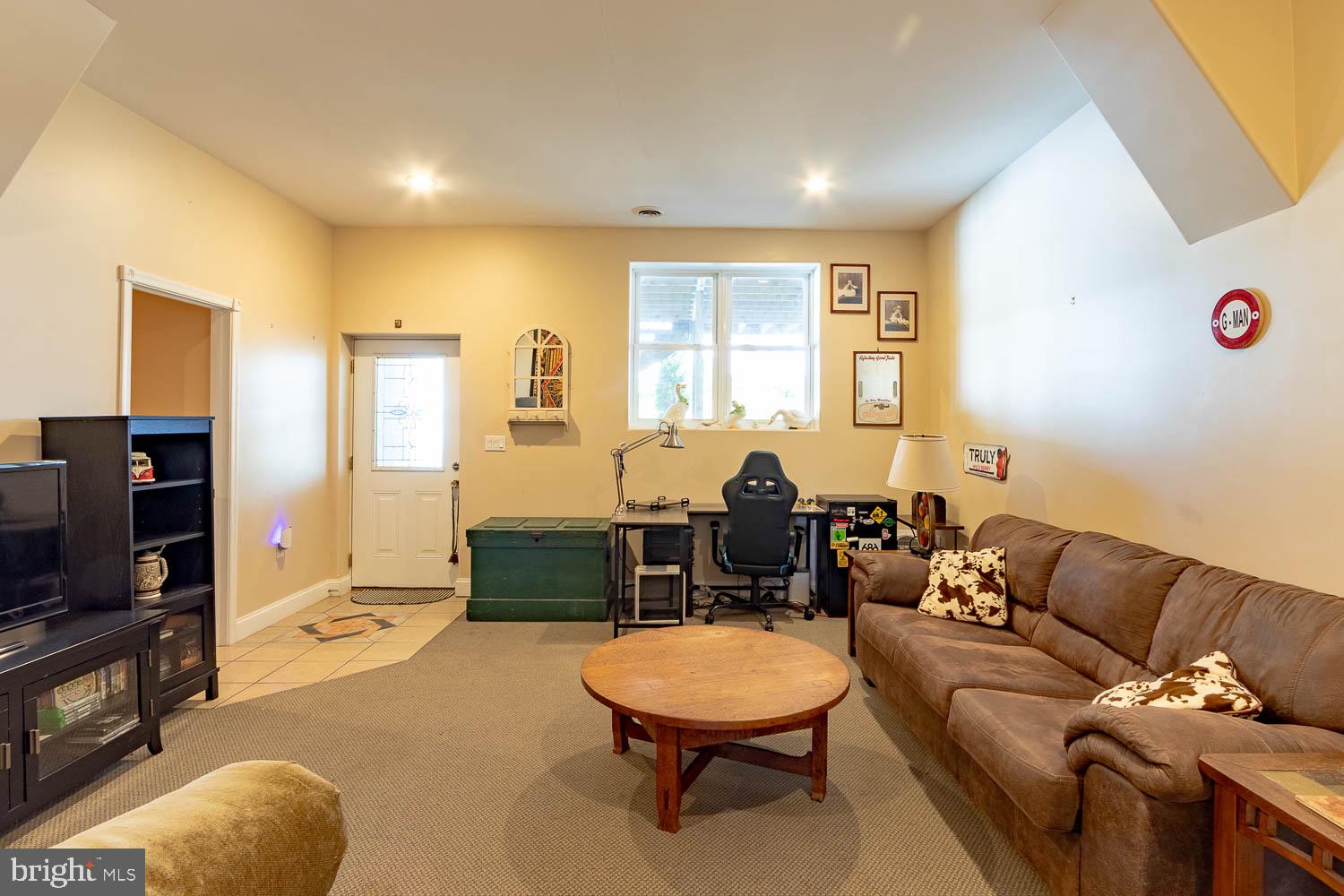 321 Mount Nittany Road Lemont, PA 16851 - Photo 29 of 43 a living room with furniture and a flat screen tv