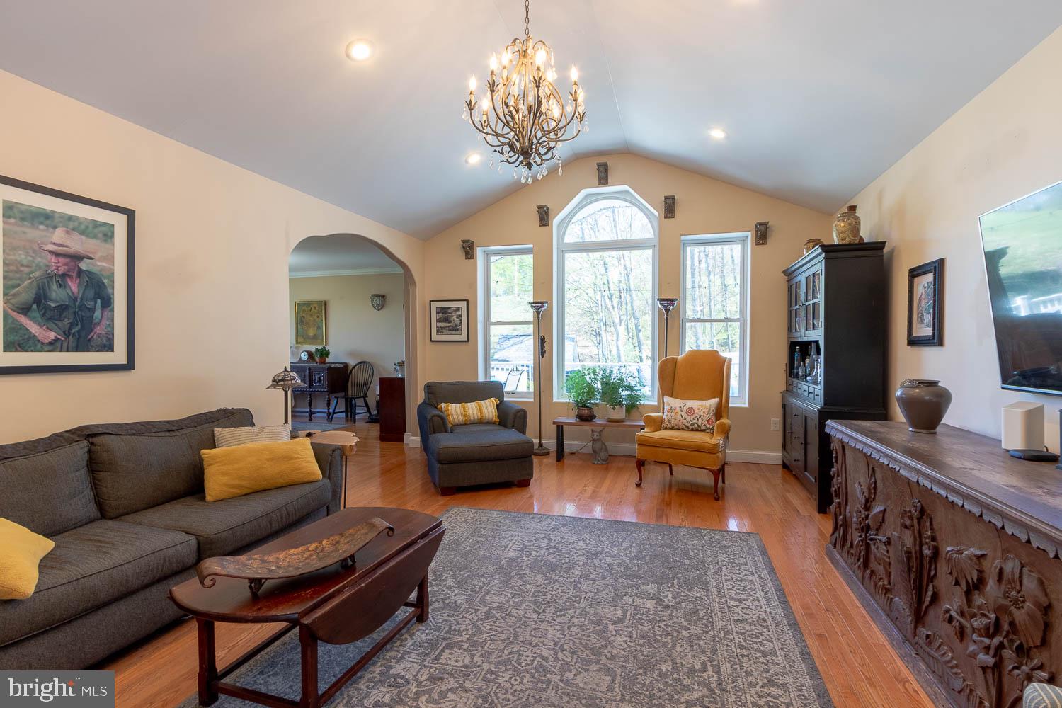321 Mount Nittany Road Lemont, PA 16851 - Photo 3 of 43 a living room with furniture chandelier and a large window