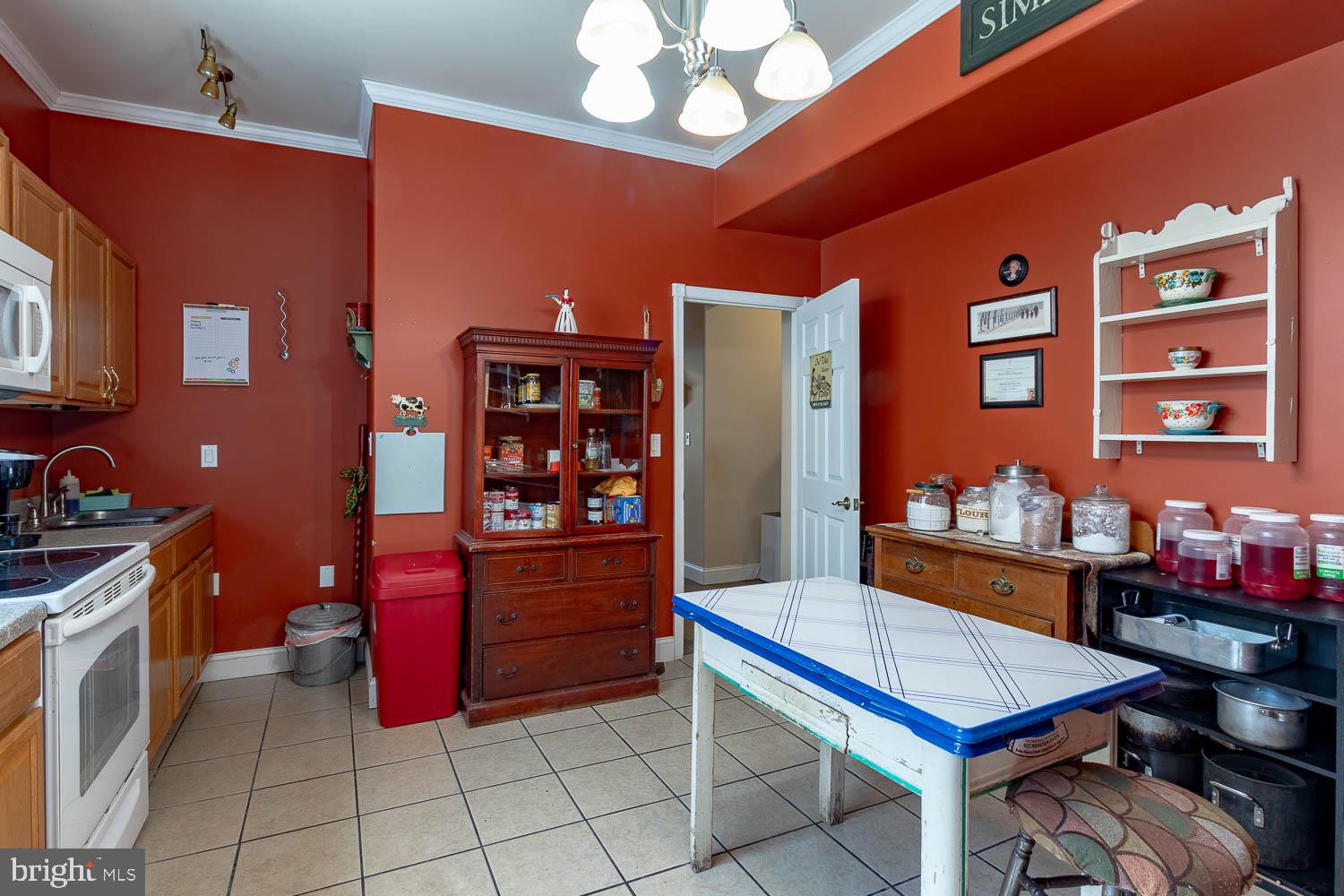 321 Mount Nittany Road Lemont, PA 16851 - Photo 35 of 43 a room with furniture a chandelier and a bookshelf