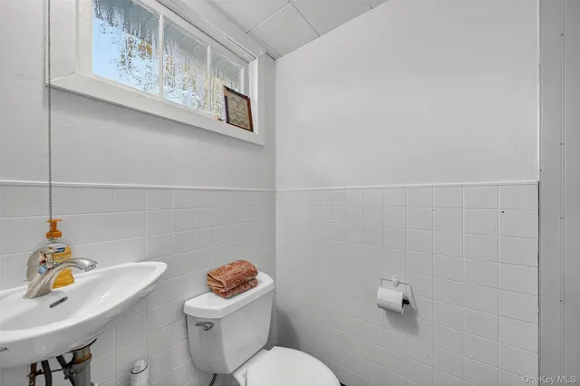 a white toilet sitting next to a bathroom sink