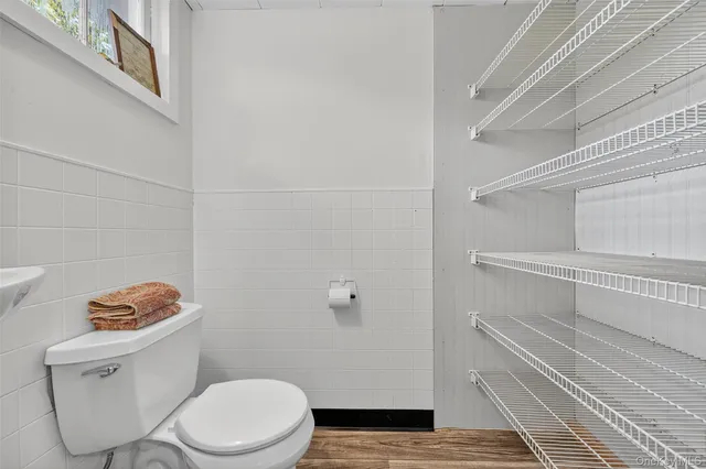 a bathroom with a sink toilet and a mirror