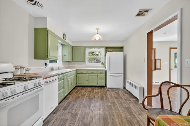 a kitchen with a stove a sink and a refrigerator